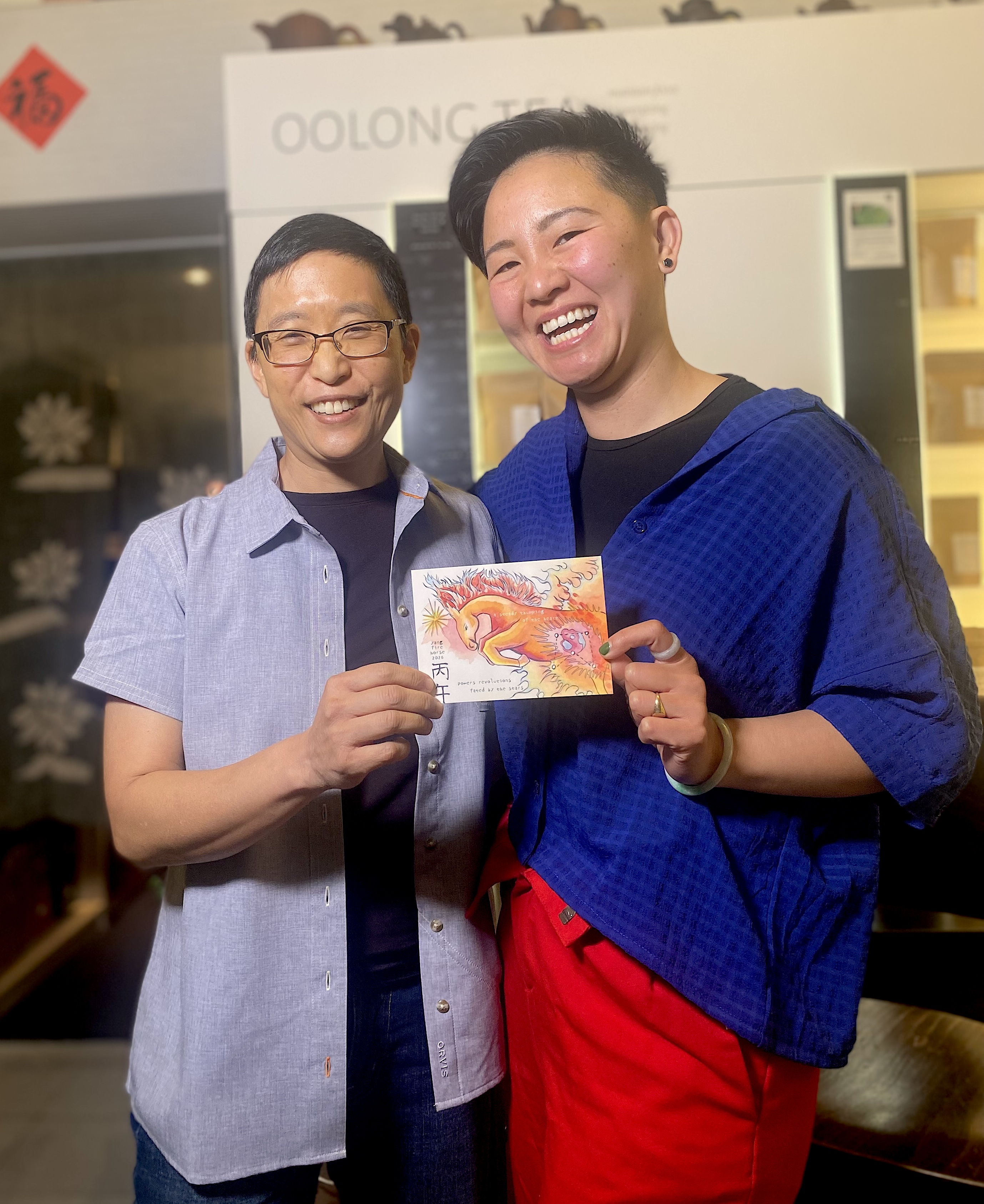 Sally Chang and forest Lin holding an image of the Fire Horse